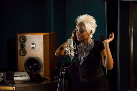 Johannesburg, South Africa - April 29, 2015: Gabriela, Mozambique singer recording vocal part on Afro-pop song in studioのeditorial素材