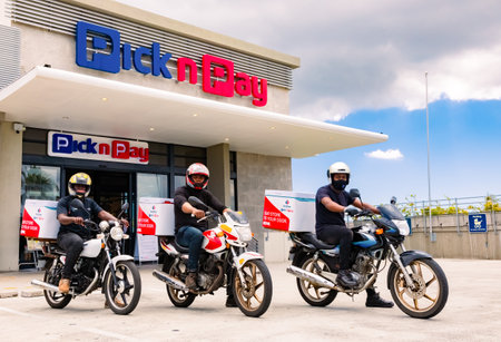 Cape Town, South Africa - December 10, 2020: Express Service home delivery bikes with African riders outside local Pick n Pay grocery storeのeditorial素材