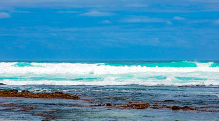 Sandy beach on western side of Cape Town peninsula on a cloudy dayの写真素材