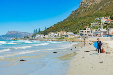 Cape Town, South Africa - March 23, 2021: Surfers and swimmers at Muizenberg beachのeditorial素材