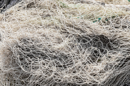 Macro close up of traditional fishing net and rope on small rowing boatの写真素材