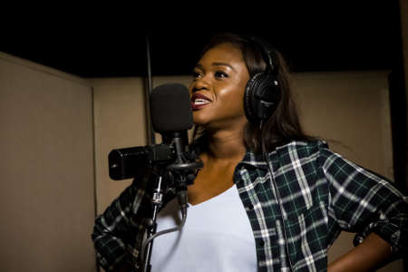 Johannesburg, South Africa - April 29, 2015: Waje Nigerian singer recording vocal part on Afro-pop song in studioのeditorial素材