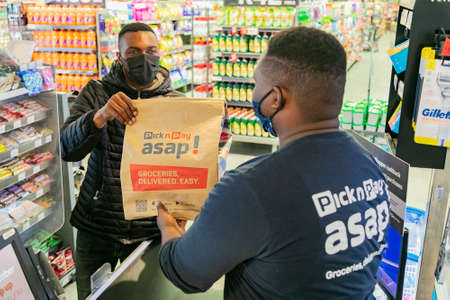 Cape Town, South Africa - September 9, 2021: Express Service delivery man collecting order from...