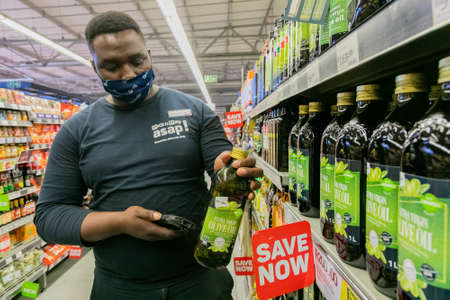 Cape Town, South Africa - September 9, 2021: Staff member picking products from shelf for express...