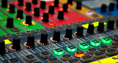 Close up of Sliders and buttons on Audio Mixing Desk at live event