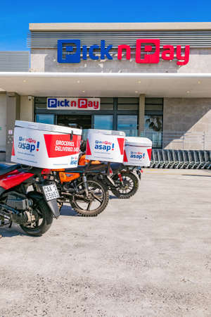 Cape Town, South Africa - September 9, 2021: Express Service delivery bikes parked outside local Pick n Pay grocery storeのeditorial素材