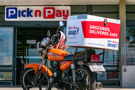 Cape Town, South Africa - September 9, 2021: Express Service delivery bike parked outside local Pick...