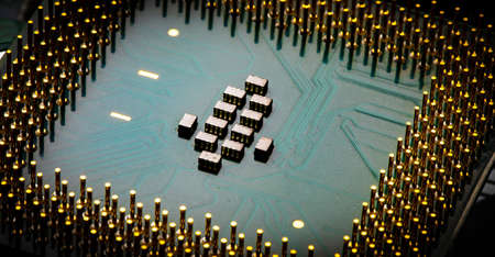 Macro Close up of microchips and pins on Main CPU PC processor circuit board.