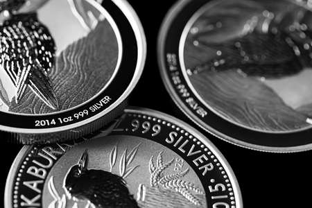 Macro Close up of  Silver Bullion Coin on a black mirror background