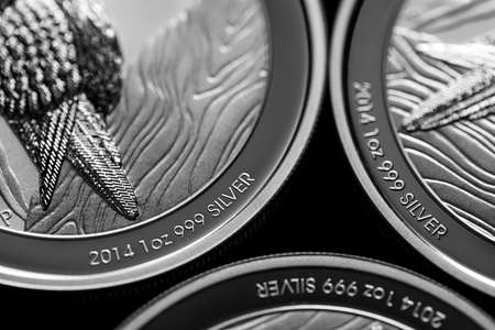 Macro Close up of  Silver Bullion Coin on a black mirror backgroundの写真素材