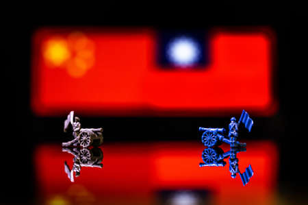Conceptual image of war between China and Taiwan using toy soldiers and national flags on a...