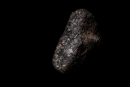 Macro Close up image of raw material Platinum and Chrome Ore rock isolated on black reflective...