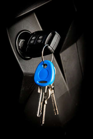 Close up of modern vehicle key in ignition slot of semi truck tractor