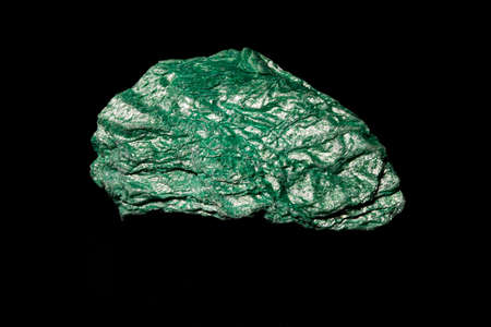Macro Close up image of raw material green Turquoise ore rock isolated on black reflective...