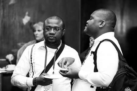 Johannesburg, South Africa - August 20, 2015: Delegates networking at a sales convention in large conference hallのeditorial素材