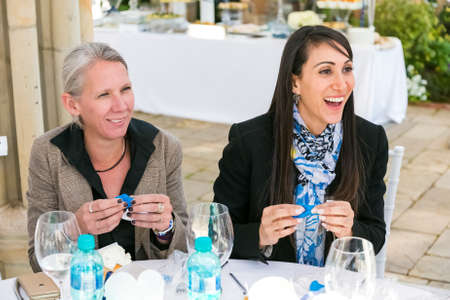 Johannesburg, South Africa - August 18, 2016: Ladies at team-building luncheon making cupcakesのeditorial素材