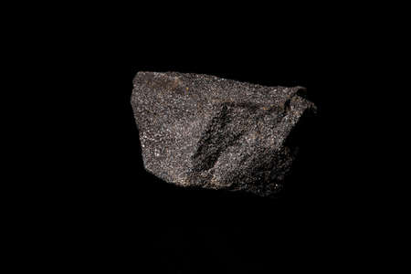 Macro Close up image of raw material Platinum and Chrome Ore rock isolated on black reflective backgroundの写真素材
