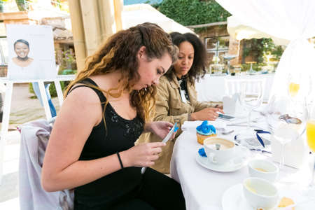 Johannesburg, South Africa - August 18, 2016: Ladies at team-building luncheon making cupcakesのeditorial素材