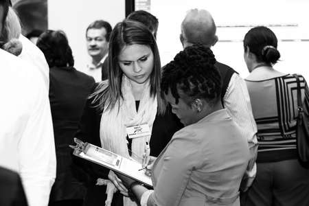 Johannesburg, South Africa - August 20, 2015: Delegates networking at a sales convention in large conference hallのeditorial素材