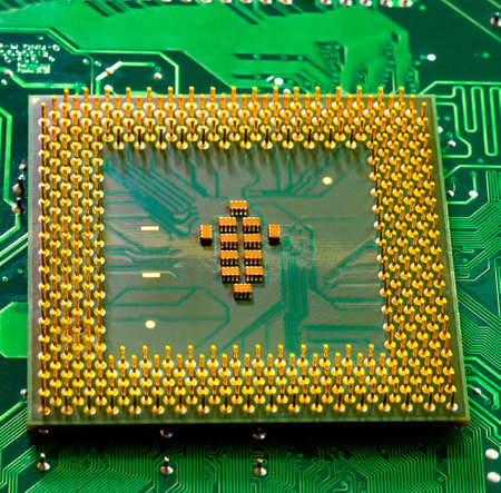 Macro Close up of microchips and pins on Main CPU PC processor circuit board.