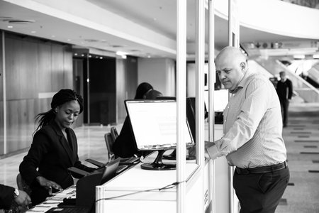 Johannesburg, South Africa - August 20, 2015: Delegates registering at sign in booth for sales convention at conference hallのeditorial素材