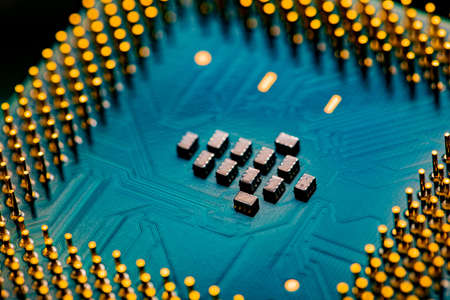 Macro Close up of microchips and pins on Main CPU PC processor circuit board.の写真素材