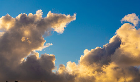 Cumulus and Stratus clouds in dramatic sunset sky over Cape Townの写真素材