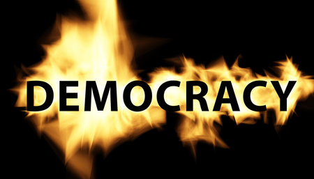 Democracy graphic text with flame fire effect on black backgroundの写真素材