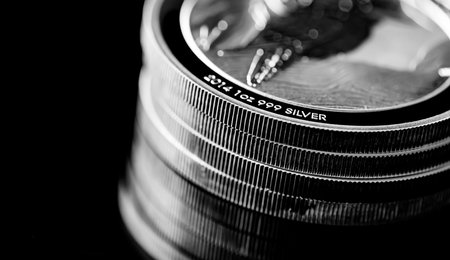 Macro Close up of  Silver Bullion Coin on a black mirror backgroundの写真素材