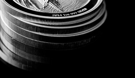 Macro Close up of  Silver Bullion Coin on a black mirror backgroundの写真素材