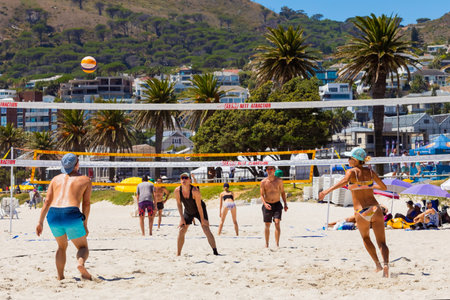 Cape Town, South Africa - February 19, 2023: Young people playing beach volleyballのeditorial素材