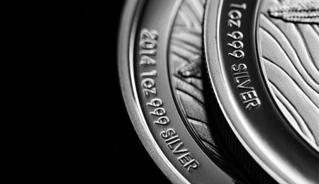 Macro Close up of  Silver Bullion Coin on a black mirror backgroundの写真素材