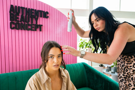 Cape Town, South Africa - November 15, 2022: Professional stylist working on young female model in hair salonのeditorial素材