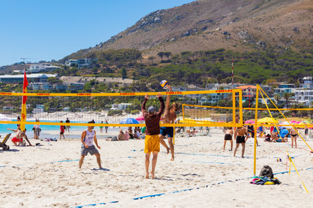 Cape Town, South Africa - February 19, 2023: Young people playing beach volleyballのeditorial素材