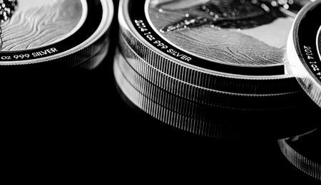 Macro Close up of  Silver Bullion Coin on a black mirror background