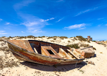 Small fishing rowboat on beach in small West Coast town of Port Nolloth, South Africaの写真素材