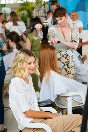 Cape Town, South Africa - November 15, 2022: Professional stylist working on young female model in hair salonのeditorial素材