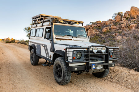 Namaqualand, South Africa - March 9, 2024: Old Land Rover Defender parked on a gravel road in arid regionのeditorial素材