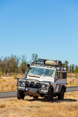 Namaqualand, South Africa - March 9, 2024: Old Land Rover Defender parked beside a national highwayのeditorial素材
