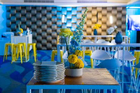 Stylish interior decor table setting at party event venue with flowers
