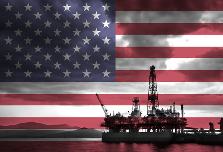 Natural Gas drilling rig with American flag overlay symbolising natural resources in countryの写真素材