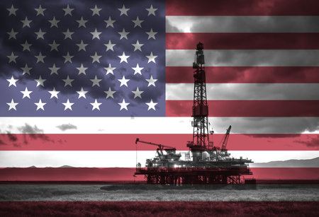 Natural Gas drilling rig with American flag overlay symbolising natural resources in countryの写真素材