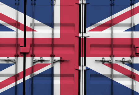 Shipping container with UK national flag overlay symbolising tariffs and international trade policies in global commerce contextの写真素材