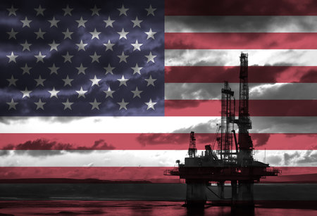 Natural Gas drilling rig with American flag overlay symbolising natural resources in countryの写真素材