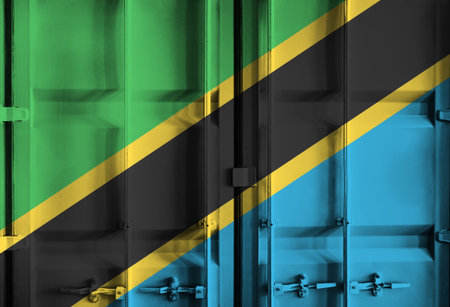 Shipping container with Tanzania national flag overlay symbolising tariffs and international trade policies in global commerce contextの写真素材