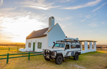 Langebaan, South Africa - November 4, 2025: Old Land Rover Defender parked outside historic buildingのeditorial素材