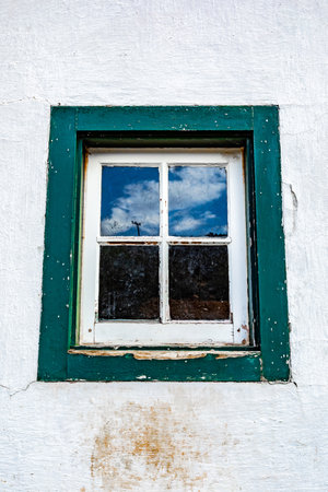 Close up detailed view of green historic colonial building window