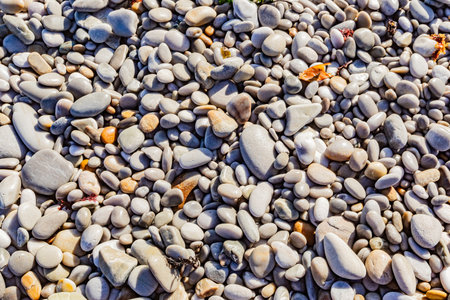 Close up view of small wet pebbles on a beach, South Africa