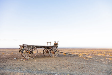 Vintage ox wagon abandoned in Karoo desert, showing weathered wood and iron fittings, South Africaの写真素材