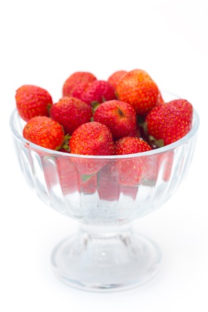 Strawberries in glass bowl on white background, selective focusの写真素材